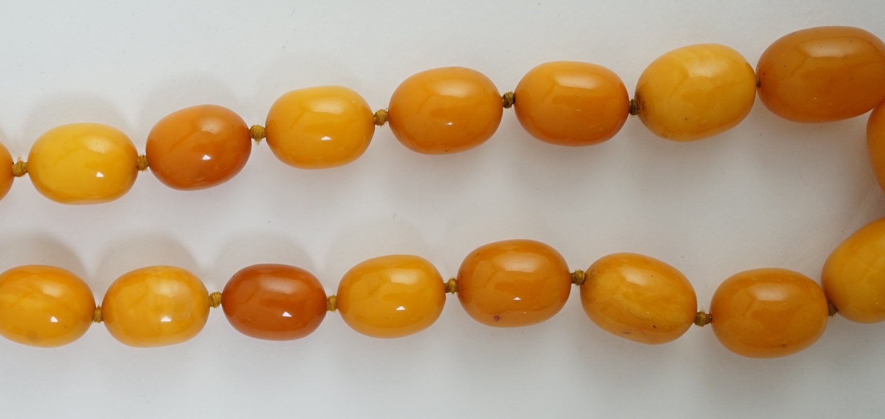 A single strand graduated oval amber bead necklace